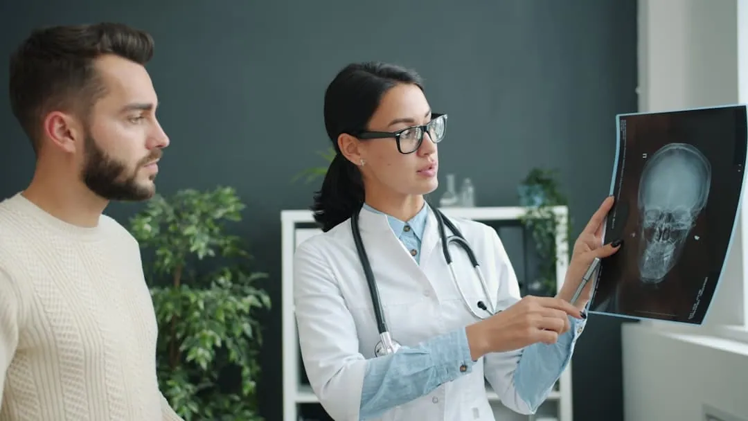 Doctor explains skull x-ray to patient -- Photo by Vitaly Gariev on Unsplash