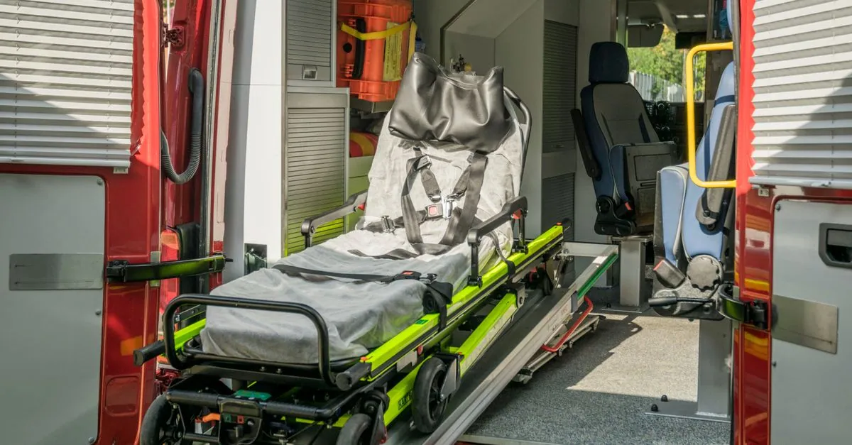Inside view of a modern emergency ambulance showing a stretcher for patient transport.